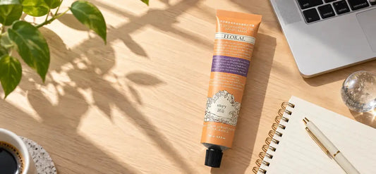 ROOPY hand cream on a bright office desk beside a laptop and notebook